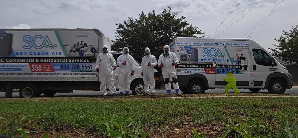 Sky Clean Air technicians in protective suits in front of their service vans
