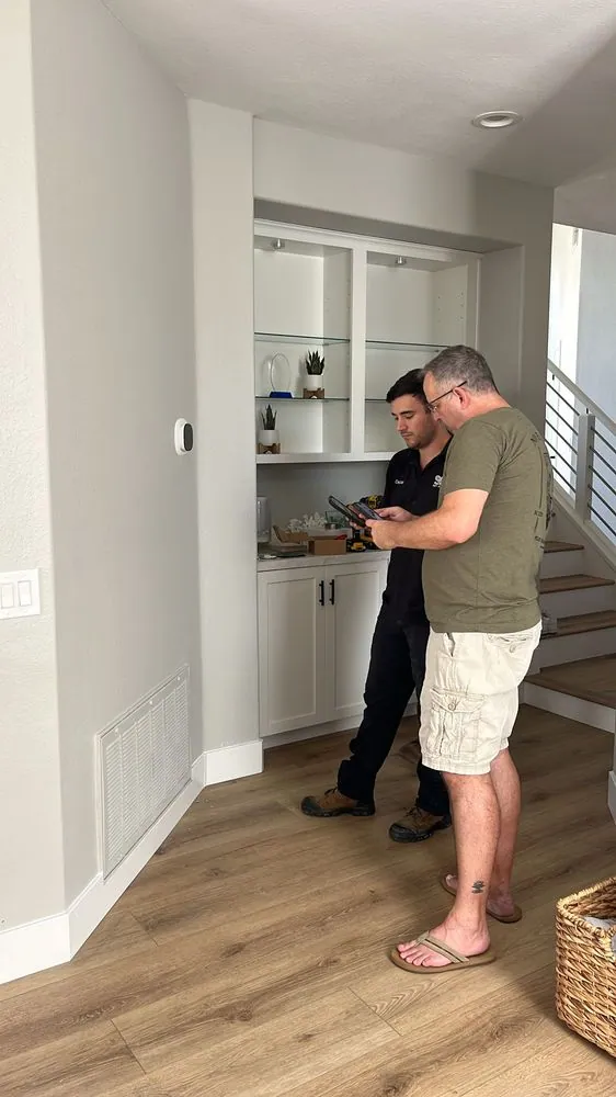A technician walking a homeowner through the findings